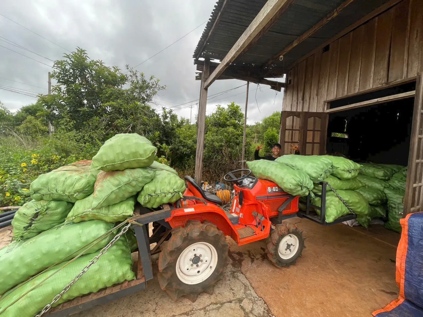 Passion fruit export batch ready — tractor pickup from farm, bottled and bagged pulp for retail and food-service buyers, 200L aseptic drums sealed, and reefer container loaded for shipment. — photo 1 of 5